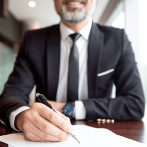 Business-Man-Signing-Paperwork-with-Pen